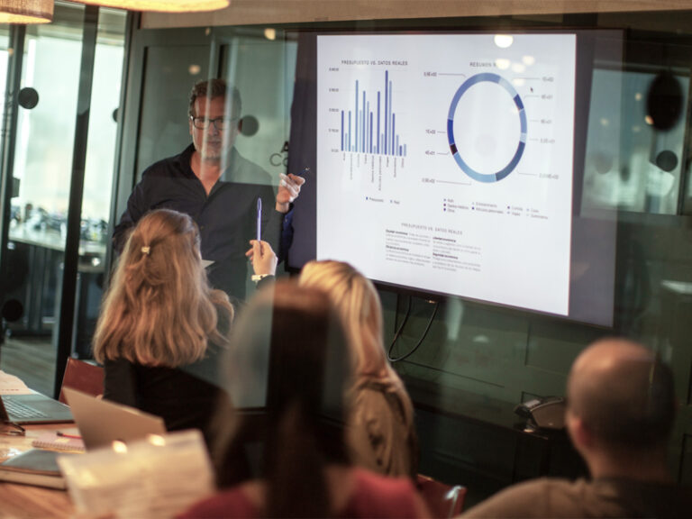 Businessman in a room of people giving presentation