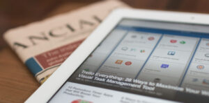 tablet and newspapers on table showing news telecommunication